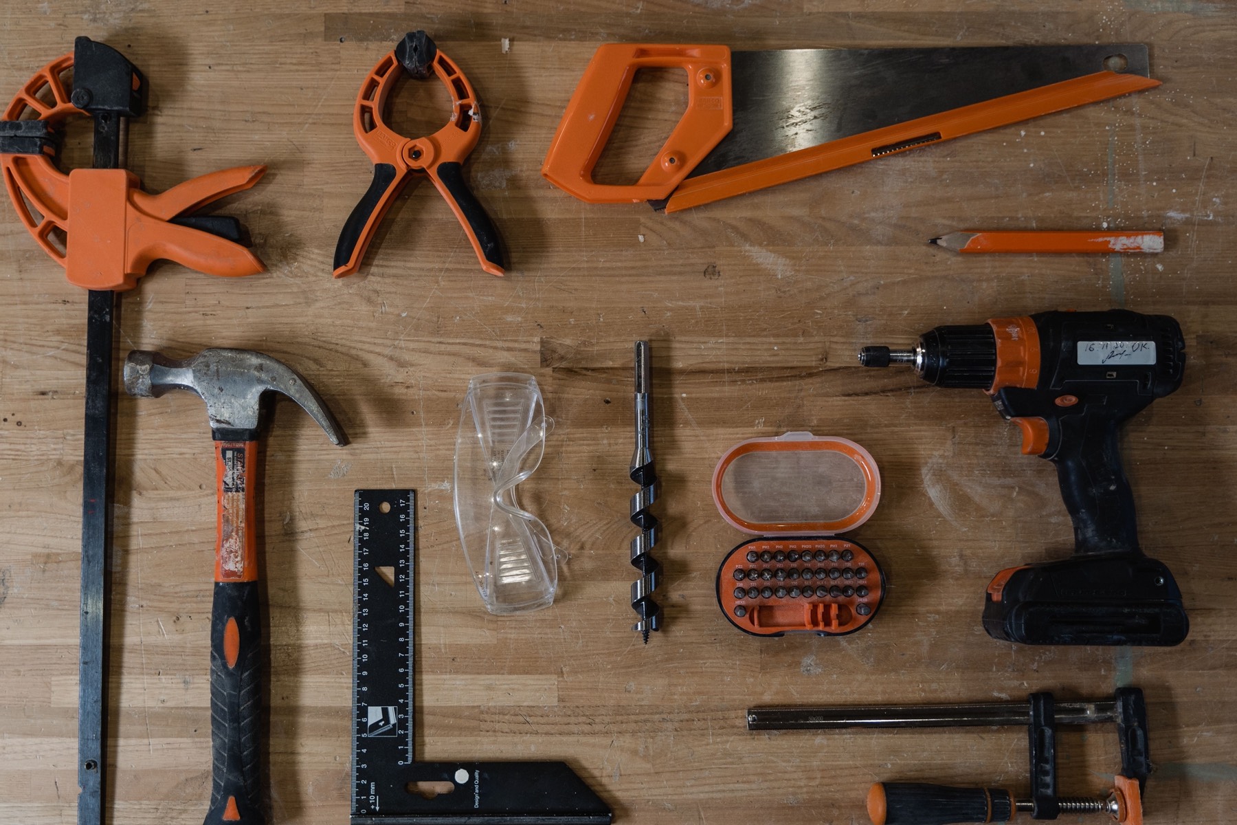 Hand tools laid out on a wooden bench