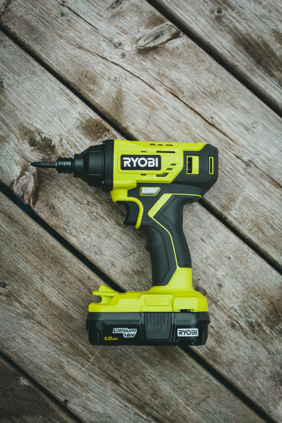Cordless drill on a weathered wooden deck