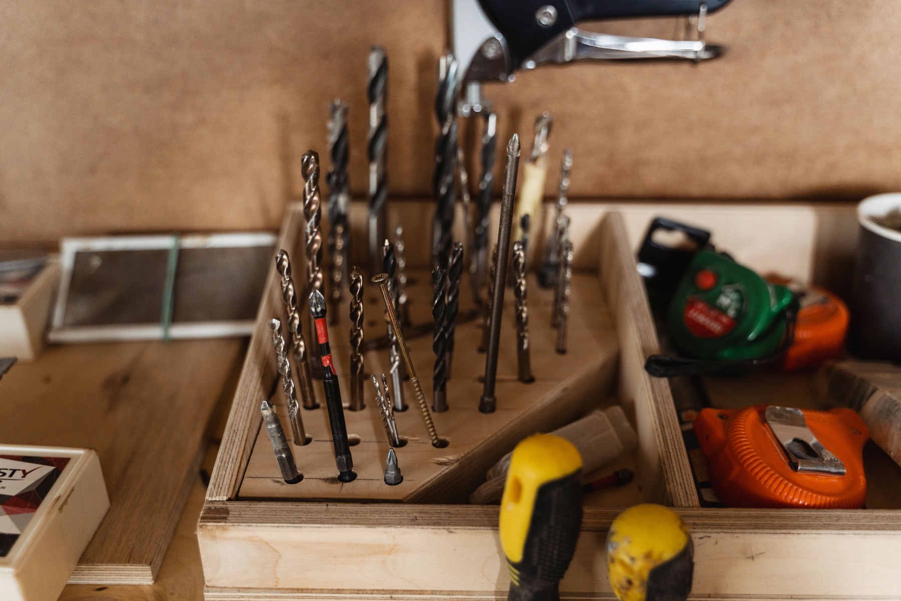 Drill bits organized in a wooden tray